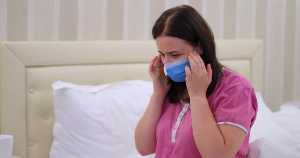Woman in Isolation with Medical Mask Having Covid 19 Symptoms
