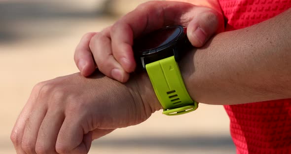 Look at a smartwatch on a man's hand.