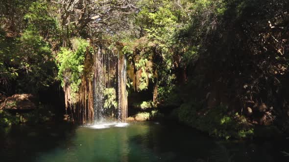Footage of a small waterfall with a clear blue plunge pool in the Blyde River canyon Gorge on the Pa alt