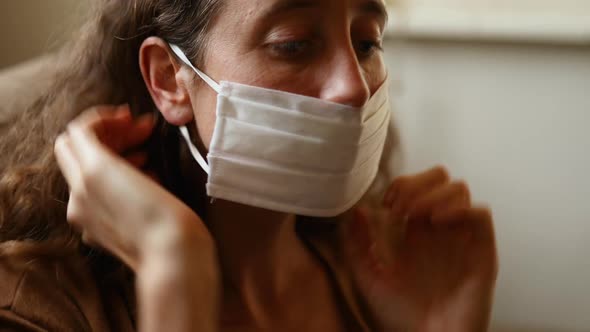 Rear view of a Caucasian and a mixed race girl talking sitting on a table alt