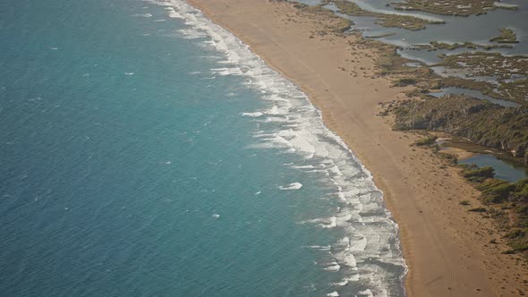 Aerial Slow Motion Waving Sea with Waves at Sunny Summer Windy Day at Beautiful Sandy Empty Beach alt