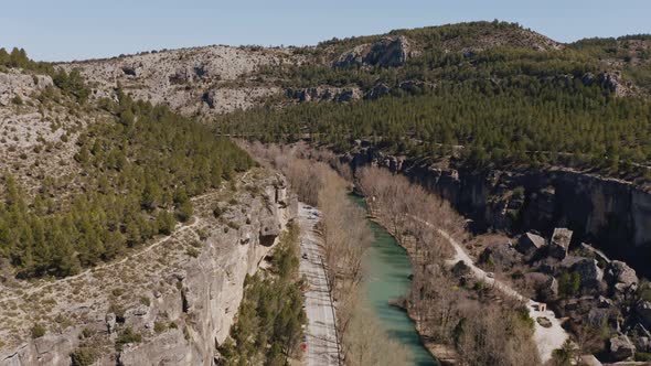 Drone view of road and river in a canyon in Cuenca, Spain alt