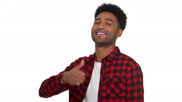 Portrait in Profile of Cheerful Darkskinned Man with Super Hairdo Showing Thumb Up Everything's All alt