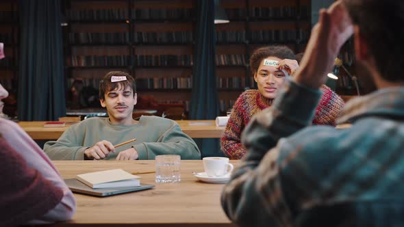 Mixed Race Young People Spend Time Playing Who Am I alt