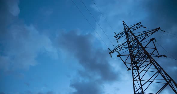 High Voltage Electricity Tower and Power Lines Against Dramatic Clouds Timelapse