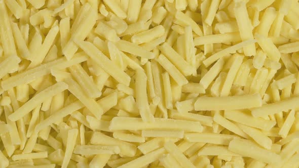 Extreme Closeup Of Grated Cheddar Cheese On Plate alt