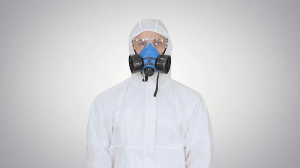 Man in Protective Suit, a Mask and a Respirator Thumbs Up on Gradient Background alt