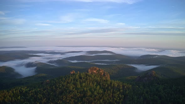 Mountain Peaks in the Fog at Dawn in the Siberian Nature Reserve Stolby