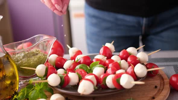 Salting Caprese Canapes with Cherry Tomatoes and Mozzarella Cheese Balls alt
