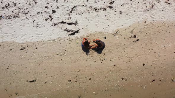 Women tanning on beautiful bay beach vacation by blue ocean and white sand background of Thailand in alt