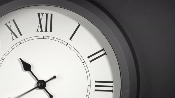 Latin Clock Face In Time Lapse On Dark Grey Wall  alt