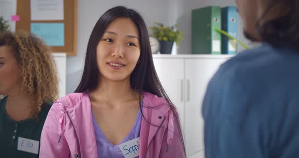 Close Up of Asian Woman Hugging Psychologist During Therapy Session in Support Group alt
