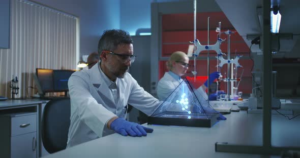 Scientist Examining Holographic Molecular Structure alt