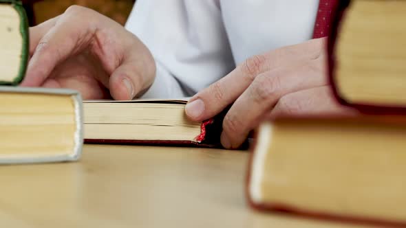 Closeup of Hands Opening a Book