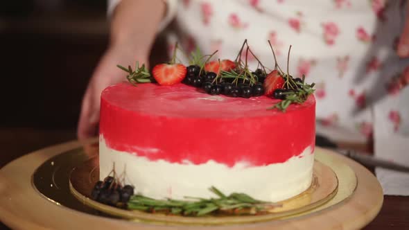 Pastry Chef Woman Is Presenting Her Layered Creamy Cake on Rotating Plate alt