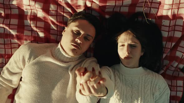 Engaged Couple Lying In The Field alt