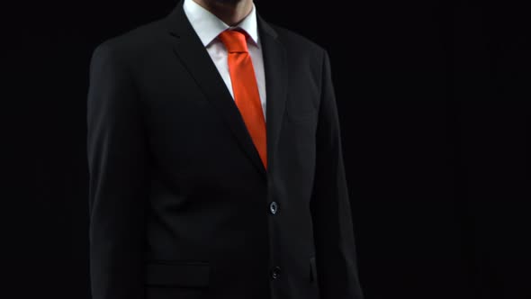 Man in Black Suit Presses His Finger in Front of Himself Then Flips Through for Business Graphic alt