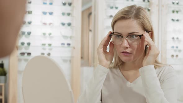Blond-haired Caucasian Woman in Optician Store alt