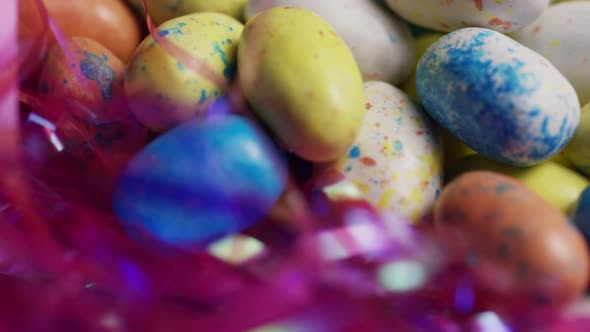 Rotating shot of colorful Easter candies on a bed of easter grass alt