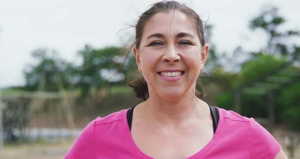 Caucasian woman looking at camera at boot camp alt