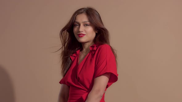 Woman in Red Dress on Beige Background alt