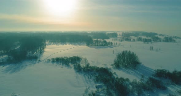 Aerial View of Cold Winter Landscape Arctic Field Trees Covered with Frost Snow Ice River and Sun alt