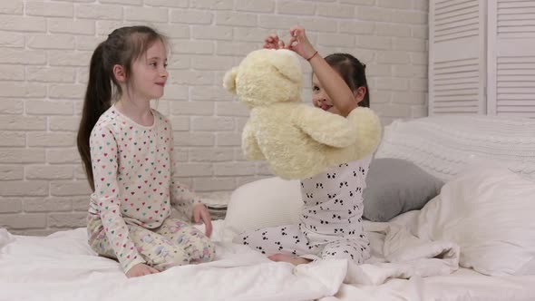 Adorable Happy Little Child Girl Playing with Teddy Bear