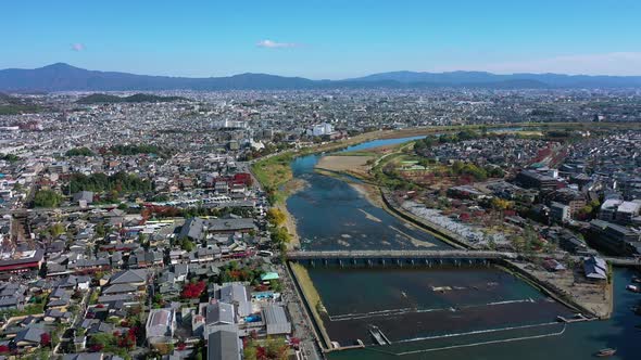 Aerial view 4k by drone of Katsura river at autumn and boats. Arashiyama, Kyoto alt