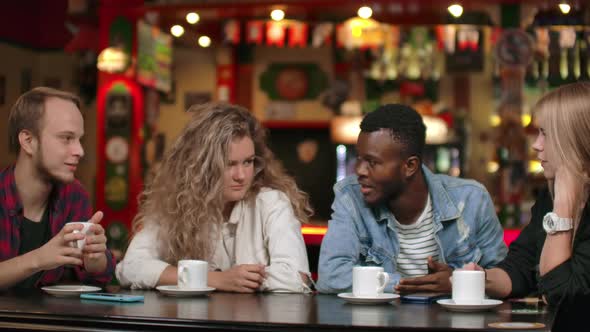 Happy Diverse Mates Having Fun with Gadget Together Watching Funny Online Video on Smartphone alt