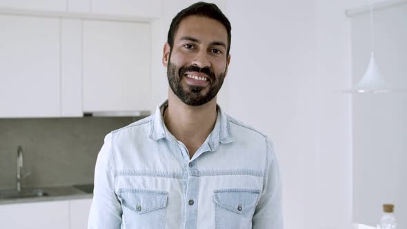 Happy Handsome Dark Haired Latin Man Posing in Kitchen alt