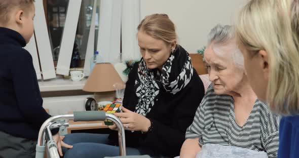 Elderly woman having visitors in hospital alt