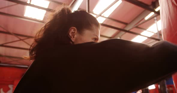 Karate player punching a boxing bag alt