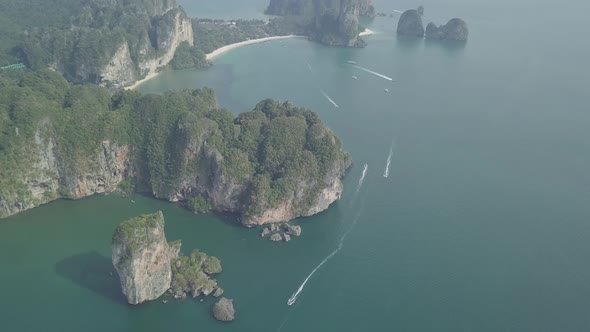 Aerial footage of Ao Nang beach, limestone rocks in sea, sailing boats. Krabi province, Thailand