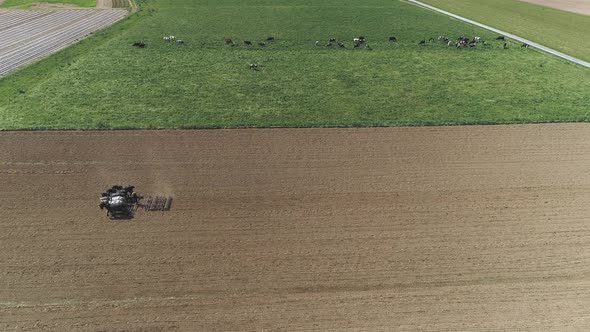 Aerial View of Amish Farm Worker Harvesting Spring Crop With Team of 6 Horses alt