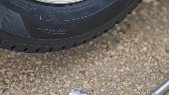 Car Wheel Lowering to the Ground Contact and Load with Car Weight alt