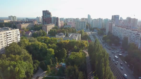 Aerial Shot of Modern City in Sunny Evening Against Sun
