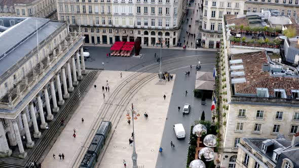 Bordeaux or Opera house Grand Theater square with people walking and trolley passing by, Aerial pede alt
