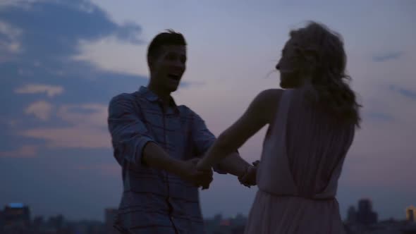 Carefree couple happily spinning in dance forgetting about all adversities alt