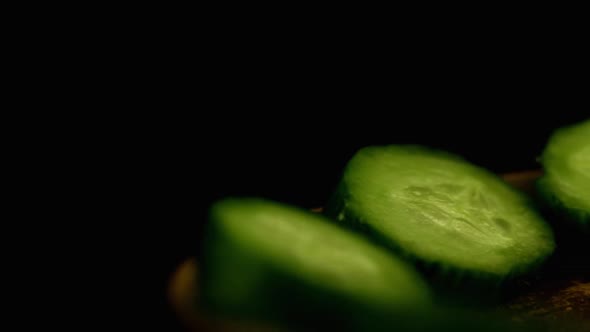 Cucumbers Rotate On A Plate On A Black Background