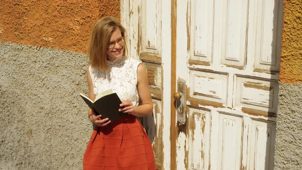 Female Model Holding a Book Going Through the Pages alt