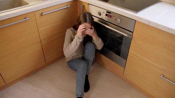POV of Angry Person Moving Towards Afraid Teenage Girl Sitting on Floor and Hiding Face in Hands alt
