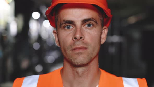 Portrait of Caucasian Ecology Worker in Hard Hat Standing at Solar Panel Control Board