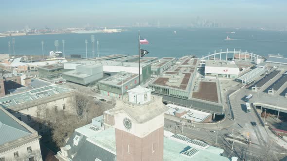 Aerial Drone Shot Orbiting an American Flag atop an old Staten Island Building