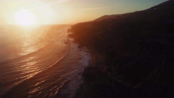 Drone footage of rippling ocean surface and the shore at El Matador Beach, Malibu, Califronia, USA alt
