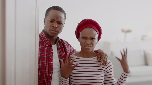 Discontented African Couple Opening The Door Expressing Aggression At Home alt
