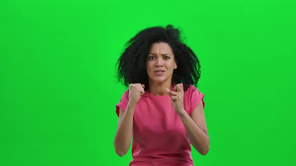 Portrait of Young Female African American Looking at Camera with Excitement and Anticipation Then alt