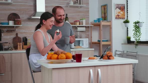 Happy Couple Waving During a Video Call alt