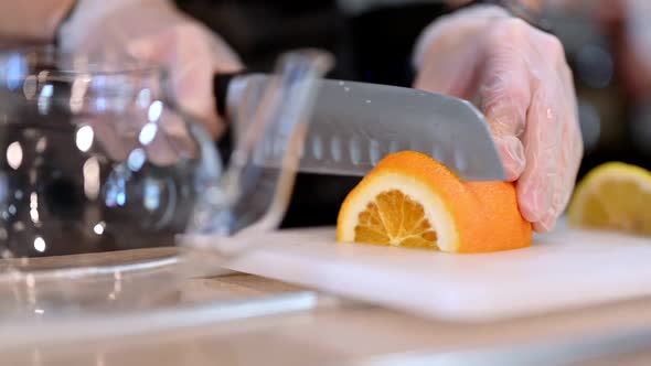 Crop Cook Cutting Orange for Drink