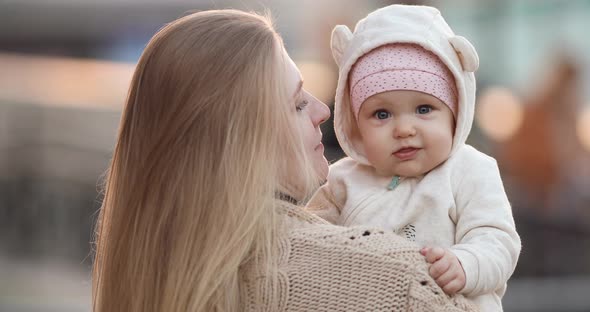 Loving Mother with a Baby in Spring Park