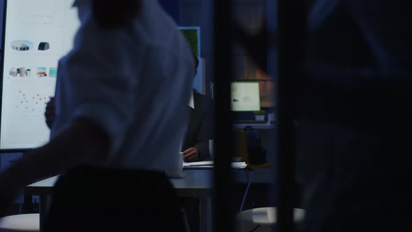 Multi Ethnic Business Teamwork Discussing Company Graphs Paperwork Sitting at Conference Table alt